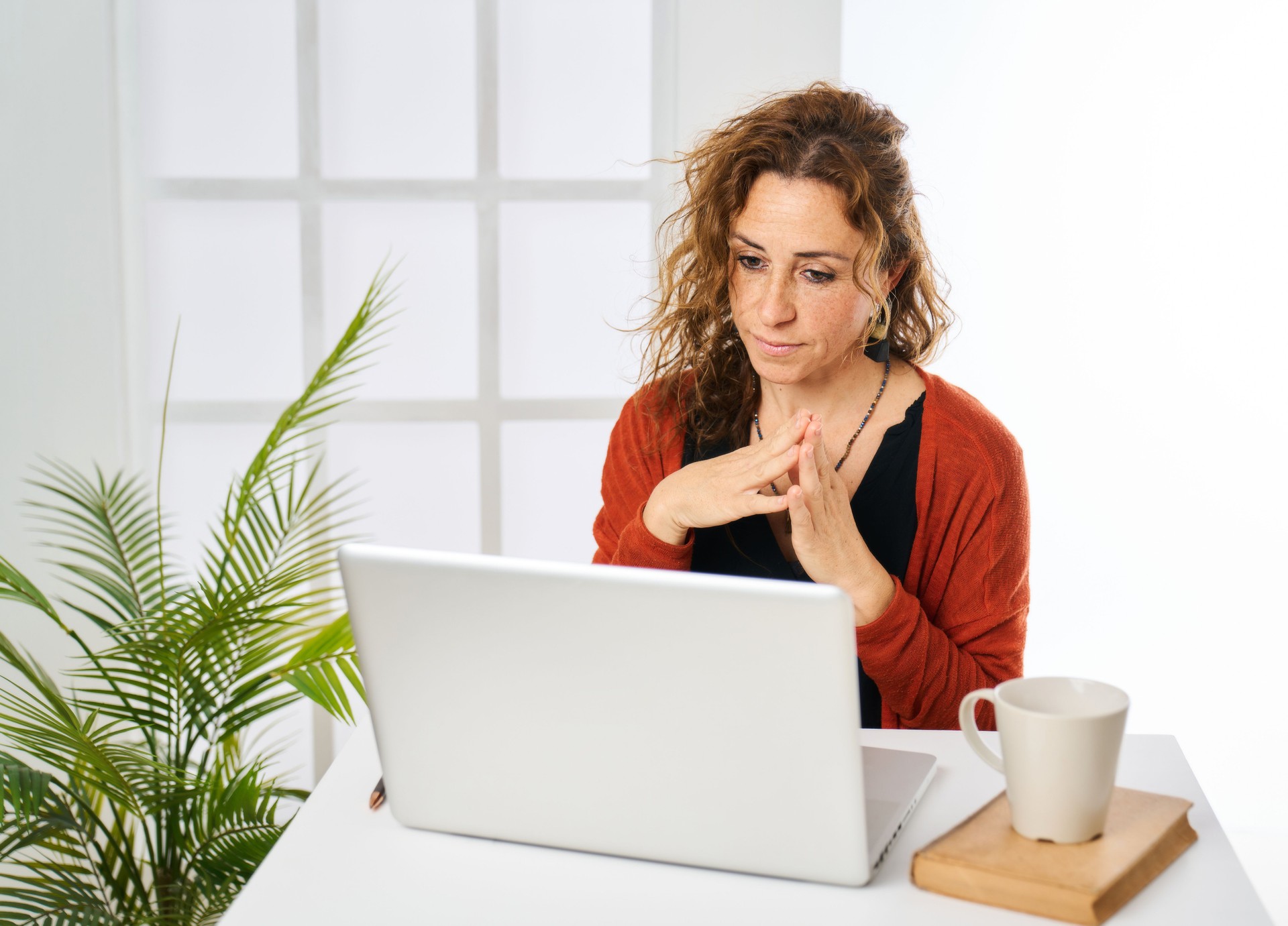 a woman working on a laptop computer at home